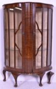 A 1940's Queen Anne revival walnut demi-lune half moon china display cabinet. Raised on cabriole