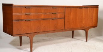 A mid century Danish inspire teak wood sideboard credenza being raised on tapering legs with  a