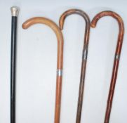 A group of four vintage walking stick canes dating from the early 20th Century to include a plan