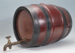 A mid 20th Century wooden and metal bound coppered barrel having lacquered body a brass tap.