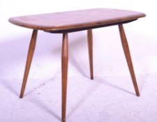 A 20th Century 1970's retro vintage Ercol elm wood coffee / side table raised on spindle legs