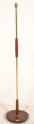 A vintage retro 20th Century teak and brass column standard lamp raised on a circular teak base.