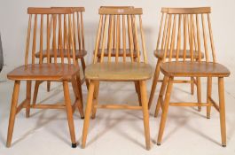 A set of 6 mid century golden beech blond wood dining chairs in the manner of Ercol. Raised on