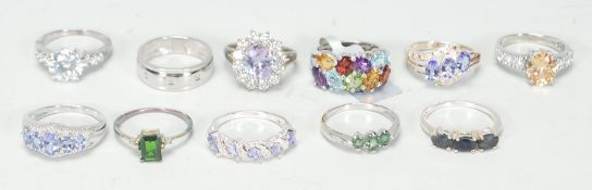 A selection of eleven silver ladies dress rings to include a ring set with three oval cut stones,