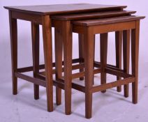 A vintage 20th Century nest of three table having rectangular tops raised on tapering block legs