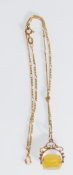 A stamped 375 9ct gold figaro link chain necklace with a 9ct gold swivel fob set with an orange