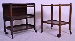 An early 20th Century Art Deco three tier tea trolley of oak construction having a drop leaf