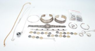 A selection of mixed silver and silver white metal jewellery to include a silver bangle with pierced