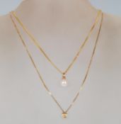 A 9ct gold pendant necklace having a fine flat link chain with a pearl pendant set to a 9ct gold