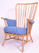 A vintage retro 20th Century Ercol beech wood spindle back armchair having turned splayed legs