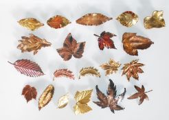 A selection of 20 fashion jewellery brooches each in the form of different leaves having a bronzed