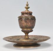 A 19th Century Islamic taste antique copper and brass inkwell having applied copper decoration