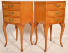 A pair of vintage mid 20th Century French beech wood bedside tables having a bank of three drawers