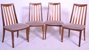 A set of four retro mid 20th Century teak framed G-Plan Fresco range rail back dining chairs