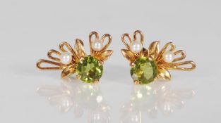 A pair of hallmarked 9ct gold earrings set with round cut peridots and seed pearls having a fan