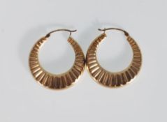 A pair of stamped 375 9ct gold hoop earrings having reeded decoration. Marked 375 to the post.