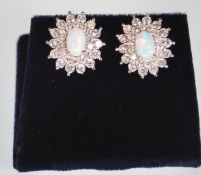 A pair of ladies stamped 925 silver stud earrings. Cubic Zirconia are set in a double halo design,