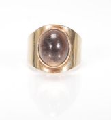 A hallmarked 9ct gold 1970's ladies dress ring set with a brown cabochon stone. Hallmarked