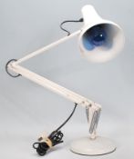 A vintage 20th Century anglepoise desk lamp raised on a round base with pendant lamp shade to top,