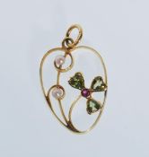 A 20th Century stamped 15ct gold open work pendant set with seed pearls, peridots and a ruby