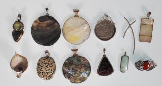 A collection of silver necklace pendants to include a silver pendant inset with a silver Britannia