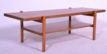 A retro 20th Century teak wood coffee table, flared top raised on turned supports united by under-