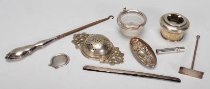 A collection of silver hallmarked and white metal items to include bottleneck, silver lid, tea