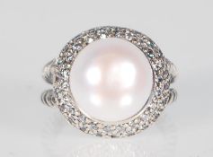 A ladies stamped 925 silver ring set with a large freshwater pearl which are surrounded by Cubic
