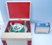 A vintage retro 20th Century two tone portable Falcon made record player having a BSR turntable. The