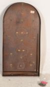 A vintage 1920's / 30's bagatelle board of domed form complete with original pins, scoring numbers
