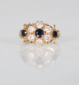 A 9ct gold ladies dress ring having a cluster of white and blue stones. Unmarked. Weight 1.9g.