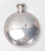 A good early 20th Century silver hallmarked moon flask / hip flask having a screw top. Hallmarked