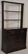 An Edwardian early 20th Century ebonised dresser having twin panelled doors to the base with two