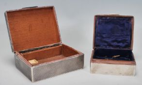 A group of two silver hallmarked desktop / cigarette boxes to include an engine turned box having