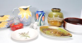 A mix group of Poole Pottery ceramic wares dating from the mid Century to include a jug and bowl