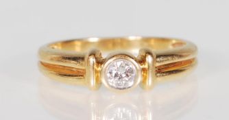 A good 18k yellow gold single solitaire diamond ring of approx 15pts setw within a decorative shaped