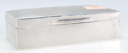 A early 20th Century silver hallmarked cigarette box of rectangular form having curved top to the