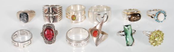 A selection of 12 Silver rings to include a silver ring with iridescent greek key design, a 925