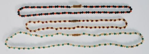 A group of three vintage ladies beaded necklaces to include a pearl and red stone necklace, a
