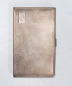 A large mid 20th Century English silver cigarette case of rectangular form having engine turned body