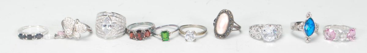 A collection of ten silver ladies dress rings to include a butterfly design ring set with white