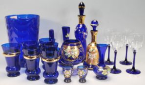 A good collection of 20th Century blue glassware to include a large blue glass vase, decanters,