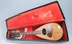 A late 19th Century Antonio Salvino Italian olive wood mandolin having an oval soundhole with mother