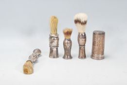 A good group of four vintage 20th Century silver handled shaving brushes of varying sizes and shapes