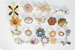 A collection of 20 vintage mid 20th Century fashion brooches to include a selection of designs