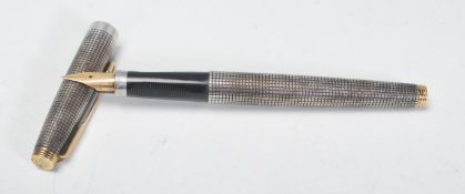A good mid to late Century sterling silver Parker fountain pen having a decorative engine turned