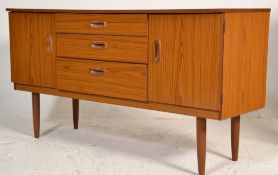 A retro mid century faux teak wood sideboard credenza being raised on tapering turned legs with a