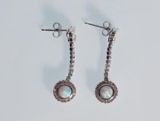 A pair of ladies silver drop earrings. Stamped 925. Cubic Zirconia are set in a knot with the drop