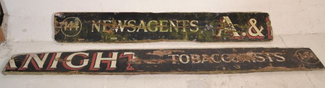 A vintage early to mid 20th Century wooden shop advertising sign having an ebonised ground with