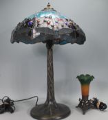 A Tiffany style table lamp having a leaded stained glass shade with blue glass panels and glass